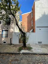 Because the back entrance (accessed from a cobblestone alley) was concealed by a brick wall, the Philadelphia Historic Commission approved an application to add a sun room extension, but specified it should clearly look contemporary.