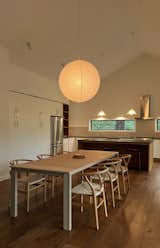 Al Stone made Zoe's dining room table, which is paired with Wayfairer chairs. The kitchen island (also made by Al) is topped with EleMar Oregon leathered granite countertops.