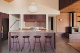 Josh Kjenner's design devoted a majority of the square footage to ground-floor public areas: a combined living-dining-kitchen area that's conducive to entertaining. The kitchen stools are by Bouclair.