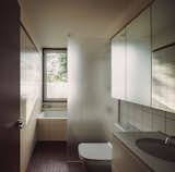 The upstairs bathroom is clad almost entirely with tile: Daltile's Colour Wheel Classic for the walls and Keystone for the floor. The Durastyle toilet is by Duravit.