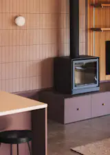 The tiles behind the stove are by Micro, and the wall sconce by Viscosi. The home's builder, Etchbuilt, fabricated the custom drawer pulls.