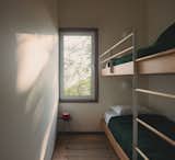 The cabin's two upstairs bedrooms are compact, including this bedroom for the couple's two young children.