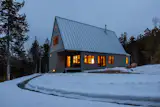 The home's steeply pitched roof, inspired by traditional Japanese farmhouses known as minkas, is useful during Maine's snowy winters.