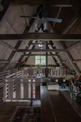 The home's exposed ceiling makes room for two small his-and-hers mezzanine studios. What you won't find, per Scott's insistence, is any diagonal knee-bracing between any of the posts and beams: a more elegant structural solution inspired by Japanese timber-framed houses.