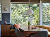 The new dining space is anchored by a vintage teak table from Portland's Century 21. The hanging lamp is original to the house.