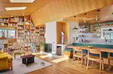 The living room now feels more spacious and full of light thanks to a cathedral-style ceiling with skylights, while the kitchen is connected with the space as one large great room.