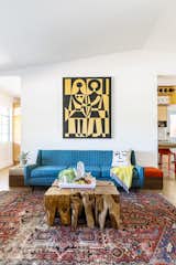 In the living room, a vintage tapestry by Alexander Girard anchors the space. The sofa was found on Craigslist, and the rug was purchased from Blue Parakeet Rugs.
