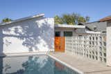 The homeowner designed the seven-foot-deep pool and concrete breeze wall themselves. 