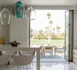 Christopher Kennedy Compound 2016 featuring LaCantina's Aluminum Folding Door System with bronze anodized finish in dining room.
