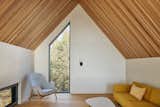 The upper loft incorporates a pull-out bed, providing extra space for sleeping. Unique windows throughout the Bunkie allow for curated views of the surrounding landscape.