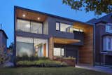 The house’s stepped façade, defined by projecting and retracting volumes, is highlighted by contrasting cladding to emphasize the volumetric gestures. Western red cedar fills the void left by retracted volumes, providing a striking foil to the charcoal gray exterior.