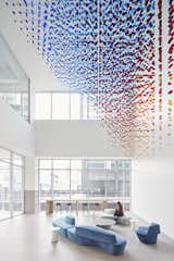 When viewed from various perspectives, new patterns and shifts in geometry emerge. When looking straight through from the upper floors, the installation’s red-and-blue binary gradient is revealed.