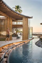 Exterior, Beach House Building Type, Wood Siding Material, Curved RoofLine, Glass Siding Material, and Tile Roof Material  Photo 6 of 16 in Al Suave House by Cincopatasalgato
