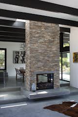 Modern Atrium House

The owners, inspired by mid-century modern architecture, hired Klopf Architecture to design an Eichler-inspired 21st-Century, energy efficient new home that would replace a dilapidated 1940s home. The home follows the gentle slope of the hillside while the overarching post-and-beam roof above provides an unchanging datum line. The changing moods of nature animate the house because of views through large glass walls at nearly every vantage point. Every square foot of the house remains close to the ground creating and adding to the sense of connection with nature.