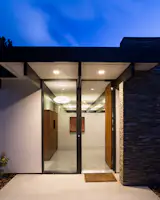 Modern Atrium House

The owners, inspired by mid-century modern architecture, hired Klopf Architecture to design an Eichler-inspired 21st-Century, energy efficient new home that would replace a dilapidated 1940s home. The home follows the gentle slope of the hillside while the overarching post-and-beam roof above provides an unchanging datum line. The changing moods of nature animate the house because of views through large glass walls at nearly every vantage point. Every square foot of the house remains close to the ground creating and adding to the sense of connection with nature.