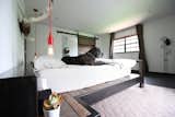 The original platform bed from seventeen20. Pendant lights and wall cactus from CB2, rug from West Elm.
