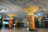 Santa Maria painted the zoo-inspired columns in the entrance of the Plaza Italia subway station. Intricate tile work at the top of each column features various types of foliage.&nbsp;