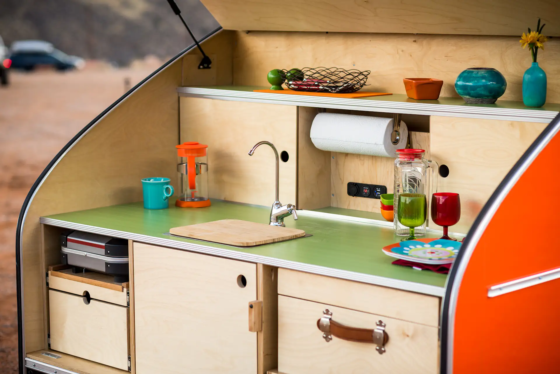 The trailer features an integrated electrical system, running water, and a custom-built cooler.