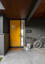This midcentury home, originally owned by a local illustrator, needed updating, remodeling, and fortifying. Seattle-based SHED Architecture &amp; Design tackled the project, keeping some classic features while updating others, like the front door in a semi-gloss orange.