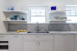 Marble Counter, Light Hardwood Floor, Stone Slab Backsplashe, Ceiling Lighting, White Cabinet, Recessed Lighting, Cooktops, and Kitchen Kitchen  Photos from Jensen