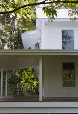 The twisting volume is glimpsed from the road, confusing and delighting the locals, as it peaks out beyond the deep covered porch.