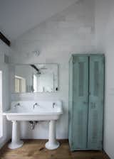 Quartz tile and original plank floors surround a 1920’s schoolhouse sink in the vaulted second floor bathroom. The sink’s original tap openings were enlarged to accommodate modern Jado faucets, and the entire sink was re-glazed. Old turquoise locker found in a barn in upstate NY.