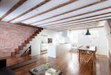 The open kitchen/living space on the ground floor opens onto a garden. Random-width pine floors salvaged from a chicken barn in upstate New York.