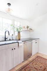 Designer Amber Lewis's "No Ordinary Kitchen" renovation features a muted palette inspired by clean Scandinavian design. Appliances by Signature Kitchen Suite, such as the dishwasher pictured here, add both style and functionality.