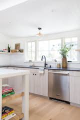 Amber Lewis's chic kitchen features a white undermount sink and a matte black faucet.