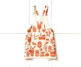 Skinny laMinx Apron, Orange Succulents
Seasonal Collection

Size: 33.5" W x 26.5" H

A lovely complement to our summer seasonal collection, you’ll find yourself reaching for this charming pinafore-style apron from Skinny laMinx—in the kitchen or studio. Adorned with a playful pattern of succulents, the cross-back pinny slips on over the head to fit people of all shapes and sizes, and the two patch pockets in front help keep hands free. The fabric is screen-printed using water-based ink on a pure cotton basecloth. We recommend hand washing in cold water, using a mild detergent, and drying on the line (don’t tumble). Made in Cape Town, South Africa.

Shop the collection here:
http://www.heathceramics.com/skinny-laminx-apron-orange-succulents

#heath #heathceramics #skinny #laminx #apron #orange #succulents 
