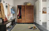 Conceal clutter behind the armoire's space-saving sliding doors. A beautiful, handcrafted piece, this armoire is the perfect scale for this entryway and keeps everything looking organized. #madeinamerica #furniture 