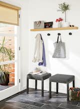 Hallway A drop-off station can consist of anything, from nothing more than a narrow shelf with a mirror above it, to a series of hooks with seating, storage, and plants.  Photo 13 of 13 in 6 Hallway Hacks to Turn Them Into Usable Space from Modern Entryway Furniture
