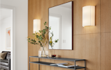 The Meara sconce features a modern, curved design and includes two LED bulbs.