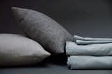 AREA Inc. PERLA celeste, a blue with a dash of green and grey. This extra-fine cotton sateen has been dyed and washed for a lived-in, relaxed style, and is very, very soft - what you see is what you get, even after you've washed it again.

LIAM soft grey, 100% baby alpaca pillows. Irresistibly soft.
