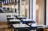 Guests Enjoy Meal Under Modern Restaurant Pendant Lighting in Sweden