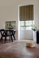 Aventura Roman Shade in material Fennimore, color Smoke. Shown over Roller Shade in Spring, color Lime.