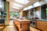 Contemporary kitchen plus wall-mounted beer taps and concealed shuffleboard table
