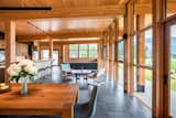 The Berm House interior living and dining with a bar made from a tree felled from the property