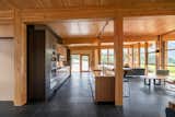 Kitchen, Wall Oven, Cooktops, Refrigerator, Slate Floor, Undermount Sink, Ceiling Lighting, Engineered Quartz Counter, and Wood Cabinet The Berm House interior with cross-laminated timber ceiling and expansive glazing, kitchen  Photo 8 of 13 in The Berm House by CAST architecture