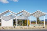 The tasting room is shaded by a folded-plate canopy that recalls the modernist designs of architect Donald Wexler.