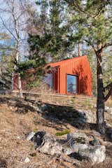A couple’s 269-square-foot getaway features a crimson exterior and an unfinished pine plywood interior.