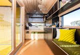 The architects included a built-in bed and bench. The cargo net above the bed acts as a children's area.