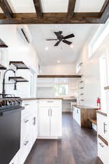 Wood floors stained the color of espresso counter the white-painted shiplap walls on the interior of the Modern model.