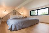 A large window in the loft-style bedroom lets in plenty of natural light.