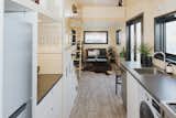Gray-toned vinyl flooring spans the open-plan kitchen and living room.