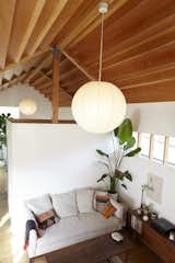 A globe-like pendant suspends from the stepped Douglas Fir ceiling in the living room.