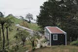 The bright red standing-seam metal roof (viewed from the main house) helped inspire the tiny home’s name: Cherry Picker.