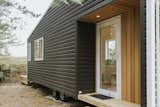 The entrance for the tiny home is wrapped in cedar, which adds warmth to the vinyl cladding.&nbsp;&nbsp;