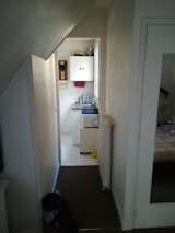 The existing kitchen displayed lackluster tile flooring and characterless cabinetry and counters.  Photo 13 of 15 in Before & After: This Hip Parisian Apartment Makes the Most of 193 Square Feet