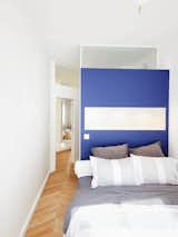 "Both of the bedrooms are master bedrooms," Petillault says. "The partition wall was an opportunity to do a beautifully colored, space-saving headboard and face the bed toward the window."